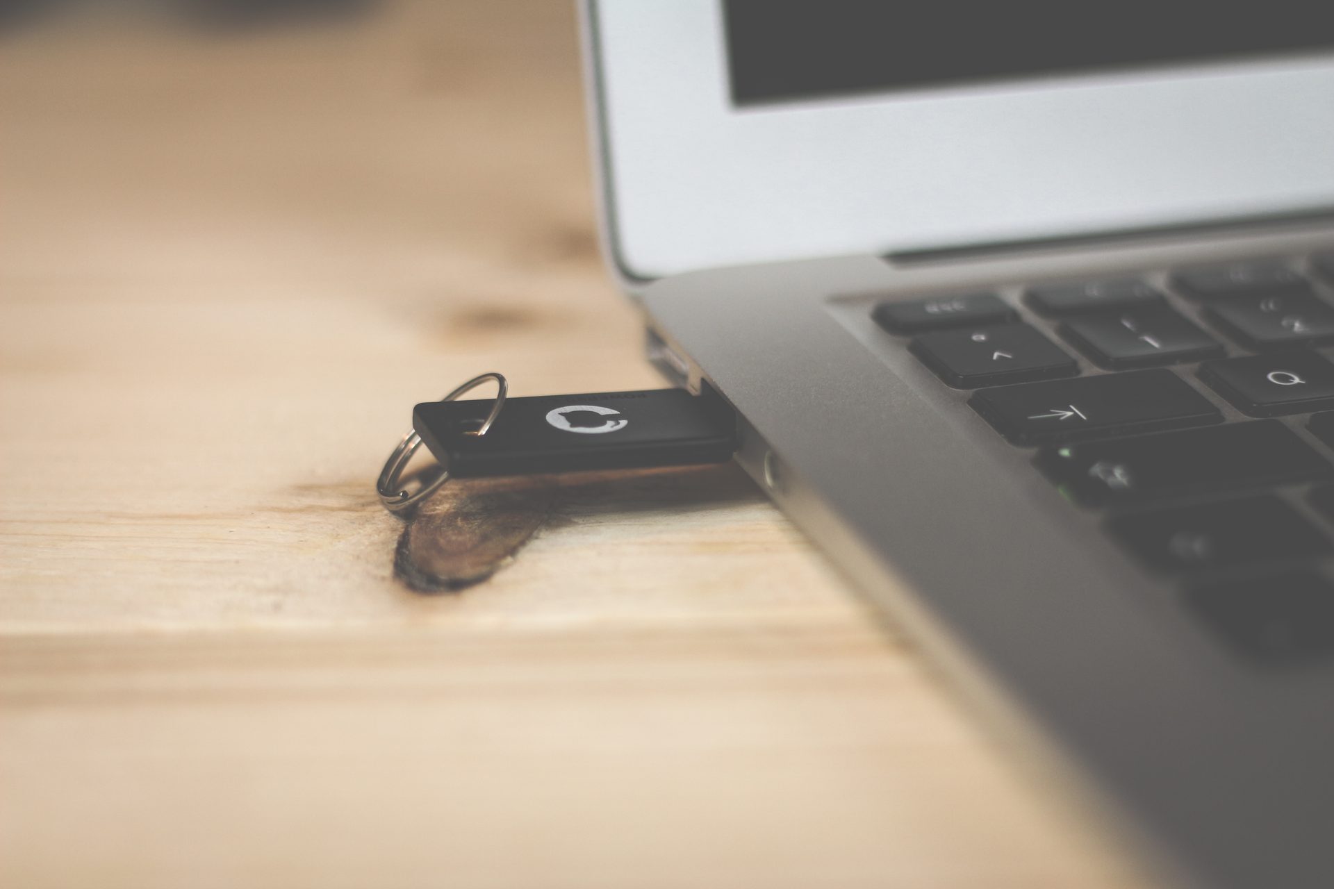 A laptop with a USB stick