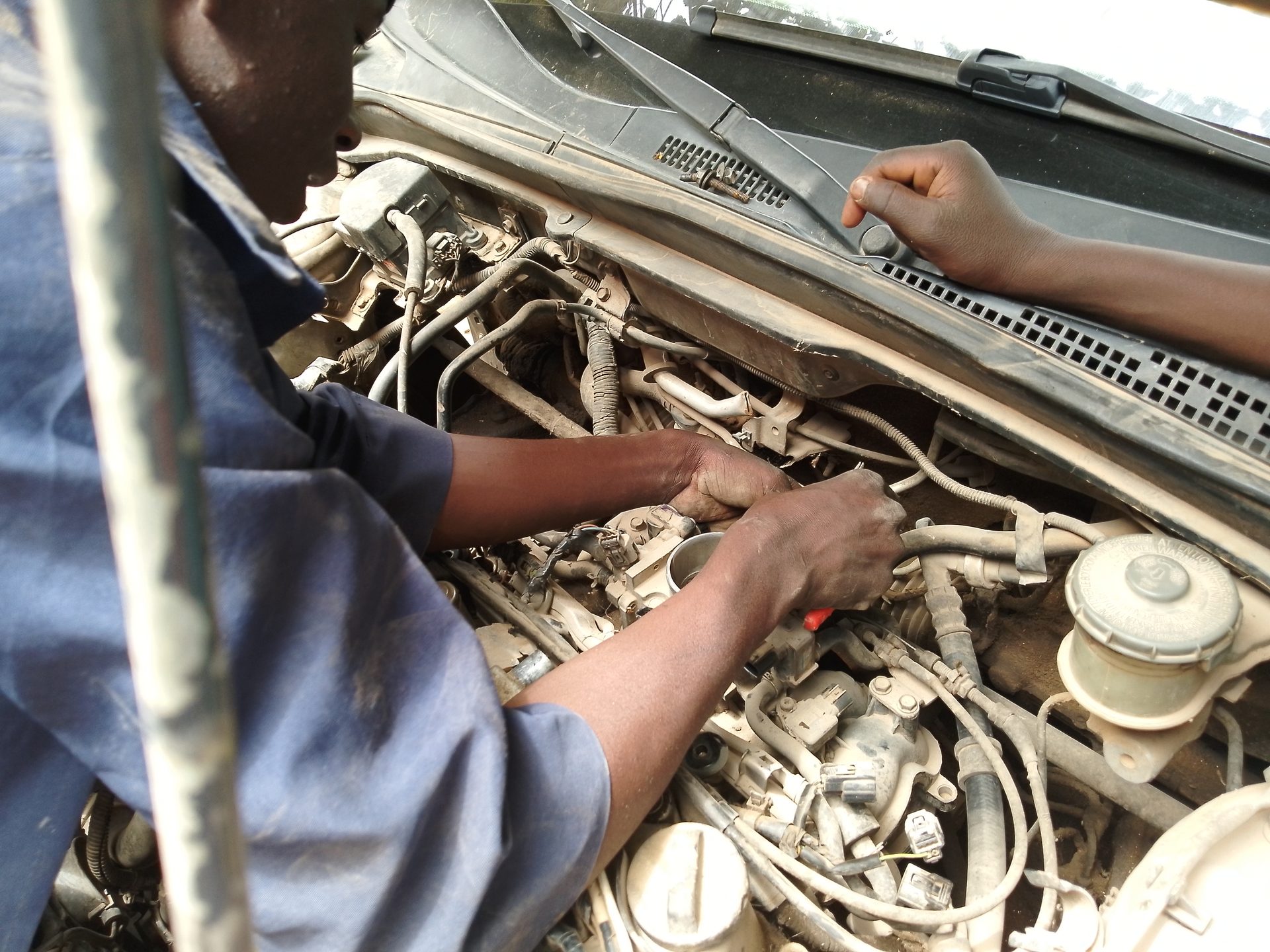 A mechanic repairing a car engine